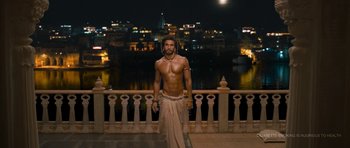 Movie still from “Goliyon Ki Raasleela Ram Leela” (2013), directed by Sanjay Leela Bhansali – A man standing on a balcony in front of a body of water at night; Wide shot, High angle