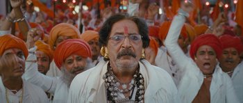 Movie still from “Goliyon Ki Raasleela Ram Leela” (2013), directed by Sanjay Leela Bhansali – An old man with a bunch of people in the background; Close Up shot, Low angle