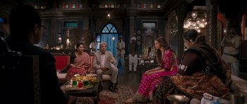 Movie still from “Goliyon Ki Raasleela Ram Leela” (2013), directed by Sanjay Leela Bhansali – A group of people sitting around a living room; Wide shot, Over the shoulder angle