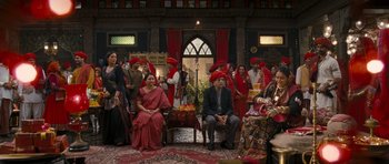 Movie still from “Goliyon Ki Raasleela Ram Leela” (2013), directed by Sanjay Leela Bhansali – A group of people dressed in red and sitting in a room; Wide shot, High angle