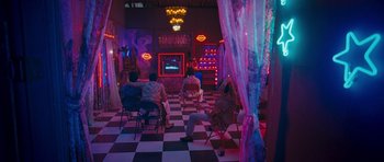 Movie still from “Goliyon Ki Raasleela Ram Leela” (2013), directed by Sanjay Leela Bhansali – People sitting in chairs in front of a television; Wide shot, High angle