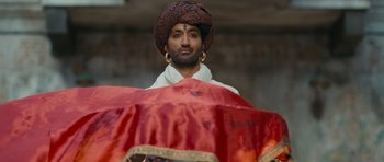 Movie still from “Goliyon Ki Raasleela Ram Leela” (2013), directed by Sanjay Leela Bhansali – A man with a turban and a red umbrella; Medium shot, Low angle