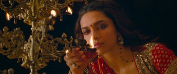 Movie still from “Goliyon Ki Raasleela Ram Leela” (2013), directed by Sanjay Leela Bhansali – A beautiful woman holding a candle in front of a tree; Close Up shot, High angle