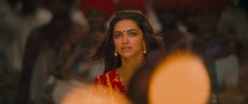 Movie still from “Goliyon Ki Raasleela Ram Leela” (2013), directed by Sanjay Leela Bhansali – Deepika padukon in a red and yellow outfit; Close Up shot, Over the shoulder angle