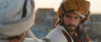 Movie still from “Goliyon Ki Raasleela Ram Leela” (2013), directed by Sanjay Leela Bhansali – A person wearing a hat; Close Up shot, Over the shoulder angle