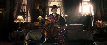Movie still from “Goliyon Ki Raasleela Ram Leela” (2013), directed by Sanjay Leela Bhansali – A woman sitting on a couch in a living room; Medium shot, Low angle
