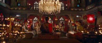 Movie still from “Goliyon Ki Raasleela Ram Leela” (2013), directed by Sanjay Leela Bhansali – A woman sitting on a pillow in front of a group of people; Extreme Wide shot, High angle