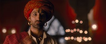 Movie still from “Goliyon Ki Raasleela Ram Leela” (2013), directed by Sanjay Leela Bhansali – A person wearing a turban with lights in the background; Close Up shot, Low angle