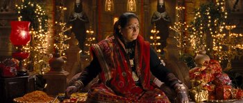 Movie still from “Goliyon Ki Raasleela Ram Leela” (2013), directed by Sanjay Leela Bhansali – An indian woman sitting on a chair in a room; Medium shot, High angle