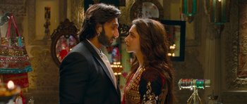 Movie still from “Goliyon Ki Raasleela Ram Leela” (2013), directed by Sanjay Leela Bhansali – A man and a woman standing next to each other; Close Up shot, Over the shoulder angle