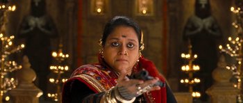 Movie still from “Goliyon Ki Raasleela Ram Leela” (2013), directed by Sanjay Leela Bhansali – A woman holding a gun while wearing a red scarf; Close Up shot, Low angle