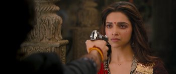 Movie still from “Goliyon Ki Raasleela Ram Leela” (2013), directed by Sanjay Leela Bhansali – Deepika padukon is holding a gun pointed at her face; Close Up shot, Over the shoulder angle