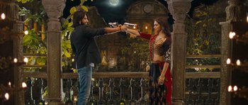 Movie still from “Goliyon Ki Raasleela Ram Leela” (2013), directed by Sanjay Leela Bhansali – A man and a woman are holding guns in their hands; Wide shot, Low angle
