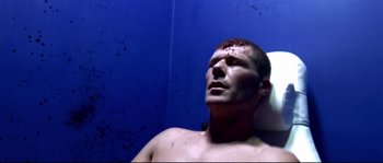 Movie still from “Gomorrah” (2008), directed by Matteo Garrone – A man with a head injury laying on the ground; Close Up shot, High angle