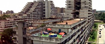 Movie still from “Gomorrah” (2008), directed by Matteo Garrone – An abandoned building with a swimming pool on top of it; Extreme Wide shot, High angle