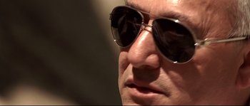 Movie still from “Gomorrah” (2008), directed by Matteo Garrone – A person wearing sunglasses; Extreme Close Up shot, Low angle