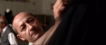 Movie still from “Gomorrah” (2008), directed by Matteo Garrone – A man's face with his hand on his shoulder; Close Up shot, Low angle