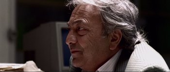 Movie still from “Gomorrah” (2008), directed by Matteo Garrone – An older man with white hair looking off into the distance; Close Up shot, Low angle