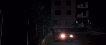 Movie still from “Gomorrah” (2008), directed by Matteo Garrone – A car driving down a street at night; Extreme Wide shot, Low angle