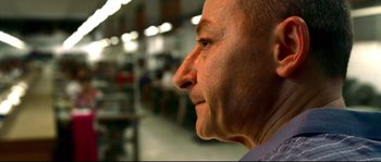 Movie still from “Gomorrah” (2008), directed by Matteo Garrone – An older man looking to his right side; Extreme Close Up shot, Low angle