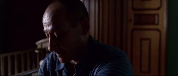 Movie still from “Gomorrah” (2008), directed by Matteo Garrone – A man's face in a dark room; Close Up shot, High angle