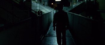 Movie still from “Gomorrah” (2008), directed by Matteo Garrone – A man walking down a ramp at night; Wide shot, Low angle