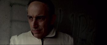 Movie still from “Gomorrah” (2008), directed by Matteo Garrone – A person wearing a white jacket; Close Up shot, Low angle