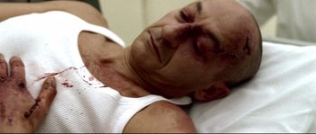 Movie still from “Gomorrah” (2008), directed by Matteo Garrone – A person laying in a bed; Close Up shot, Overhead angle