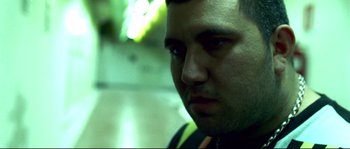 Movie still from “Gomorrah” (2008), directed by Matteo Garrone – A man's face in a dark room; Close Up shot, Low angle