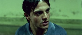 Movie still from “Gomorrah” (2008), directed by Matteo Garrone – A person wearing a necklace; Close Up shot, Low angle