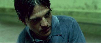 Movie still from “Gomorrah” (2008), directed by Matteo Garrone – A person wearing a blue shirt; Close Up shot, Low angle