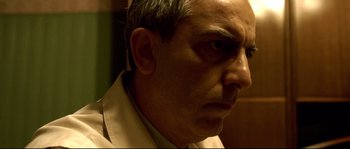 Movie still from “Gomorrah” (2008), directed by Matteo Garrone – A person wearing a white shirt; Close Up shot, Low angle