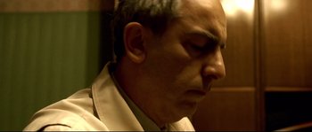 Movie still from “Gomorrah” (2008), directed by Matteo Garrone – A person wearing a white shirt; Close Up shot, Low angle