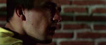 Movie still from “Gomorrah” (2008), directed by Matteo Garrone – A man's face in front of a brick wall; Extreme Close Up shot, Low angle