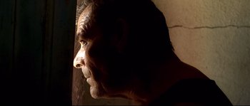 Movie still from “Gomorrah” (2008), directed by Matteo Garrone – A man's face in the sunlight; Close Up shot, Low angle
