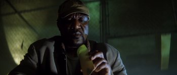Movie still from “Gone in 60 Seconds” (2000), directed by Dominic Sena – A man in a hat is holding a banana; Close Up shot, Low angle