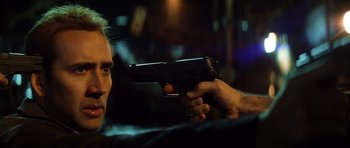Movie still from “Gone in 60 Seconds” (2000), directed by Dominic Sena – A man holding a gun up to his face; Close Up shot, Low angle