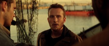 Movie still from “Gone in 60 Seconds” (2000), directed by Dominic Sena – A person wearing a jacket near a body of water; Close Up shot, Over the shoulder angle