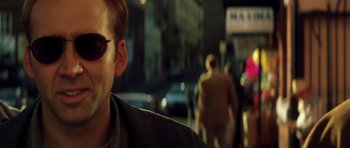 Movie still from “Gone in 60 Seconds” (2000), directed by Dominic Sena – A person wearing sunglasses on a city street; Close Up shot, Low angle