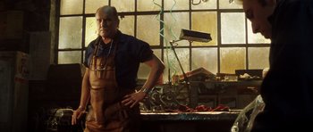 Movie still from “Gone in 60 Seconds” (2000), directed by Dominic Sena – A man in an apron standing in front of a window; Medium shot, Low angle