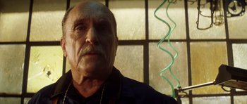 Movie still from “Gone in 60 Seconds” (2000), directed by Dominic Sena – An old man with a mustache and a beard; Close Up shot, Low angle