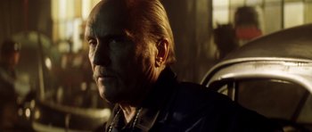 Movie still from “Gone in 60 Seconds” (2000), directed by Dominic Sena – An older man with a long hair and a beard; Close Up shot, Low angle