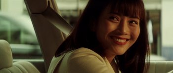 Movie still from “Gone in 60 Seconds” (2000), directed by Dominic Sena – A person with a smile on their face; Close Up shot, Over the shoulder angle