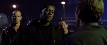 Movie still from “Gone in 60 Seconds” (2000), directed by Dominic Sena – Two men standing next to each other in a dark room; Close Up shot, Over the shoulder angle