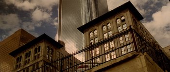 Movie still from “Gone in 60 Seconds” (2000), directed by Dominic Sena – A view of a building and a train on the side of the street; Extreme Wide shot, Low angle