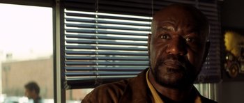 Movie still from “Gone in 60 Seconds” (2000), directed by Dominic Sena – A man's face in front of a window; Close Up shot, Low angle