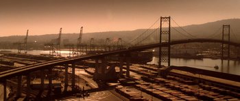 Movie still from “Gone in 60 Seconds” (2000), directed by Dominic Sena – A train yard with a bridge in the background; Extreme Wide shot, Low angle