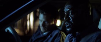 Movie still from “Gone in 60 Seconds” (2000), directed by Dominic Sena – Two men sitting in the back seat of a car at night; Close Up shot, Over the shoulder angle