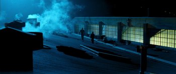 Movie still from “Gone in 60 Seconds” (2000), directed by Dominic Sena – Two people walking on the roof of a building at night; Extreme Wide shot, Low angle