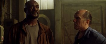 Movie still from “Gone in 60 Seconds” (2000), directed by Dominic Sena – Two men standing next to each other in a room; Close Up shot, Low angle